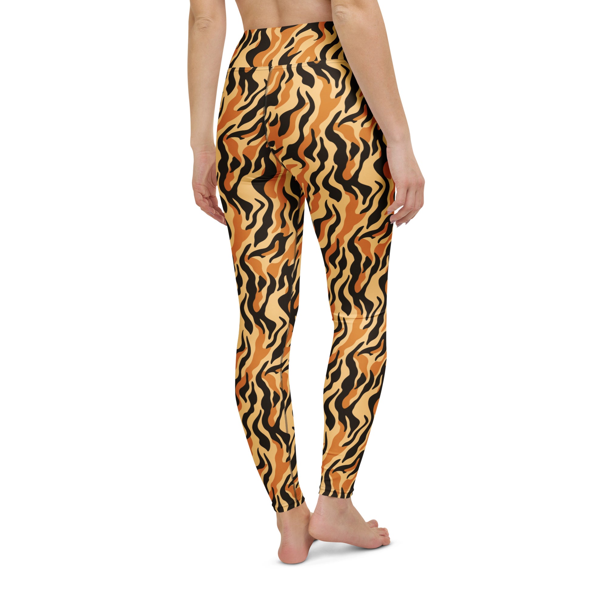 A person shown from the back wearing high-waisted leggings with a bold wavy tiger-stripe pattern in orange, black, and tan on a plain white background. High-Performance Yoga Leggings with Trendy Prints