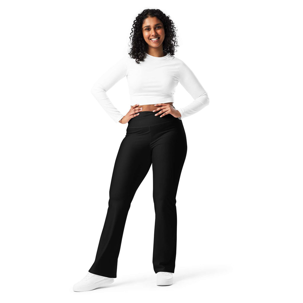 Woman wearing a white long-sleeve top and black pants on a white background Minimal Solid Black Flare Leggings for Activewear