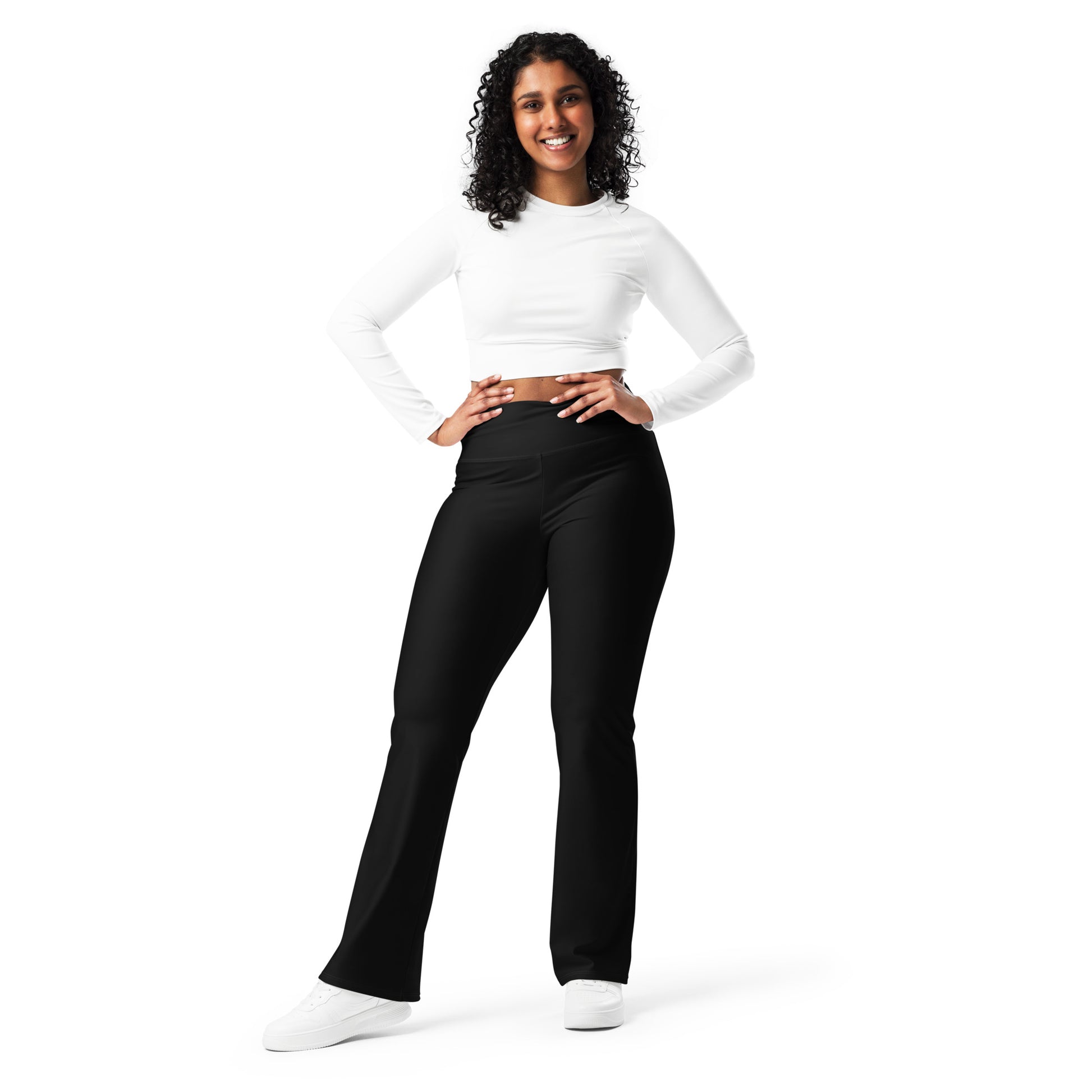 Woman wearing a white long-sleeve top and black pants on a white background Minimal Solid Black Flare Leggings for Activewear