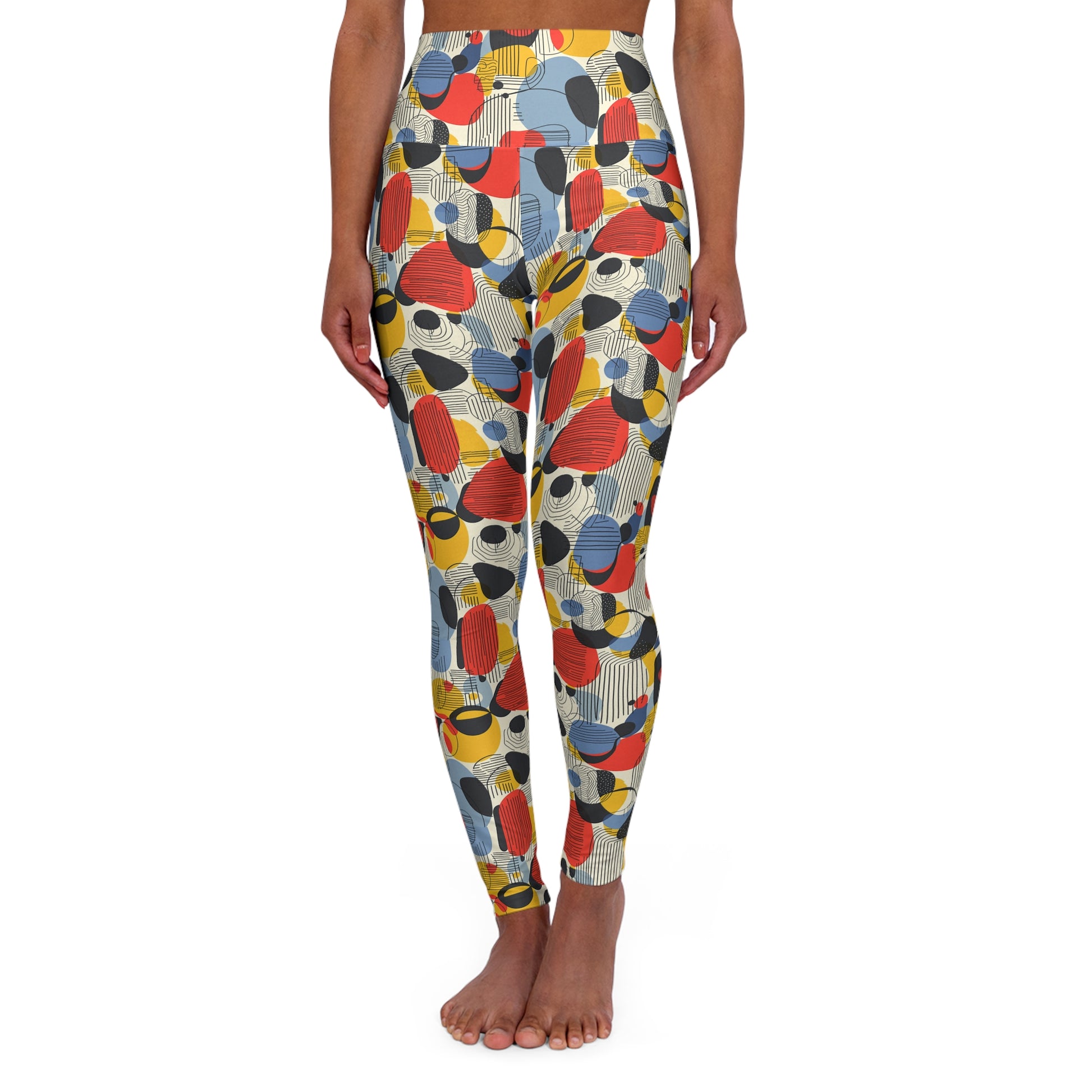 A person modeling high-waisted leggings with a colorful abstract pattern of overlapping oval and circular shapes in red, yellow, blue, black, and gray on a light beige background, shown against a plain white studio backdrop. Minimalist Bauhaus Geometric Print Yoga Leggings