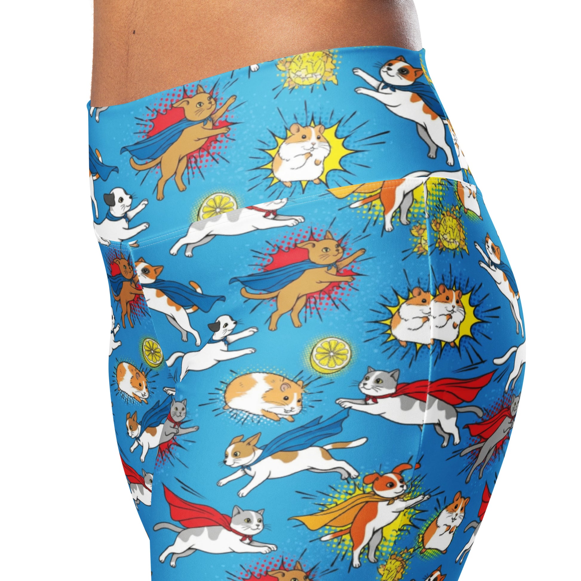 Close-up of a person wearing bright blue leggings with a playful cartoon print of cats, dogs, and superheroes flying or leaping across the fabric. Playful Whimsical Superhero Pets Printed Flare Leggings Activewear