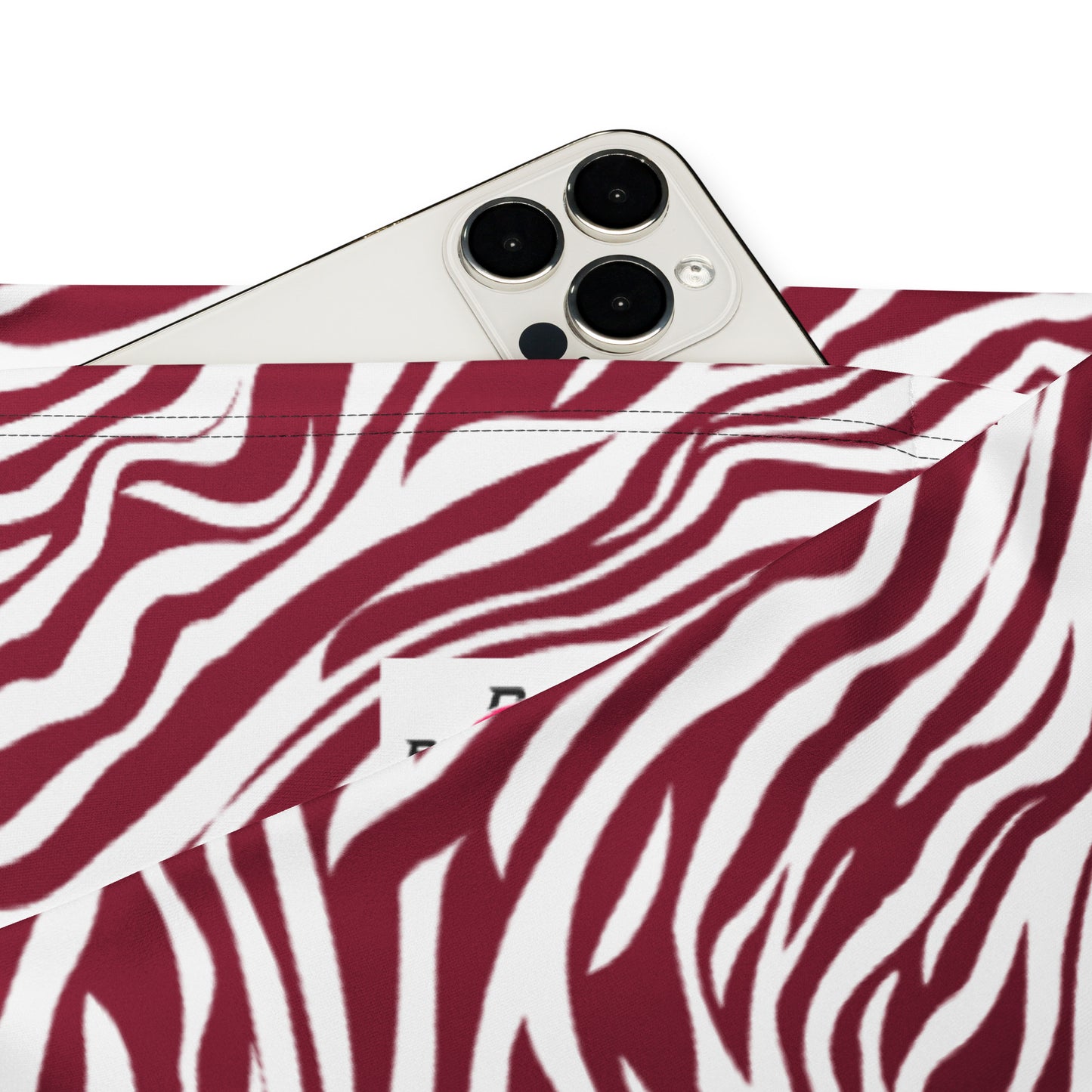 A close-up of a red and white zebra-print fabric pouch with a silver smartphone partially tucked inside, shown on a clean white background. Retro Comfortable Bold Red Zebra Print Flare Leggings Activewear