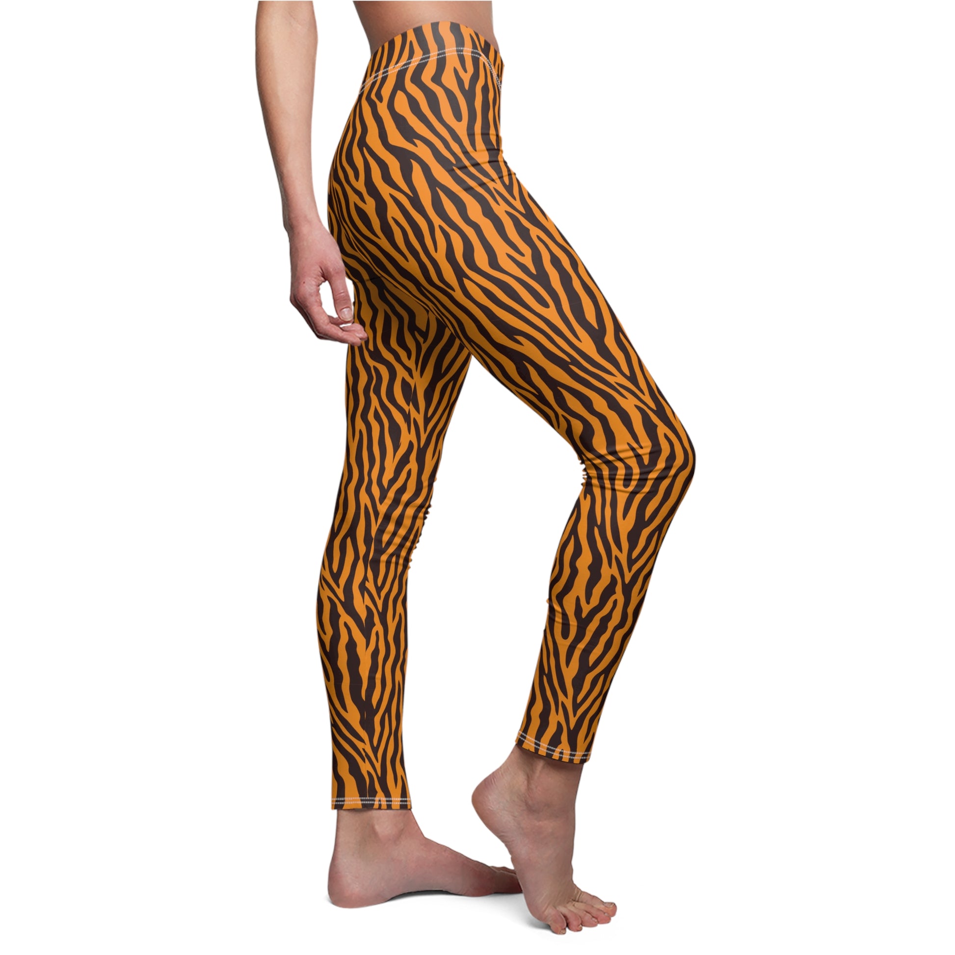 A side profile view of a model wearing high-waisted leggings with a brown and gold wavy, ripple-like pattern, set against a plain white background. Standout Orange Leggings with Animal-Inspired Design