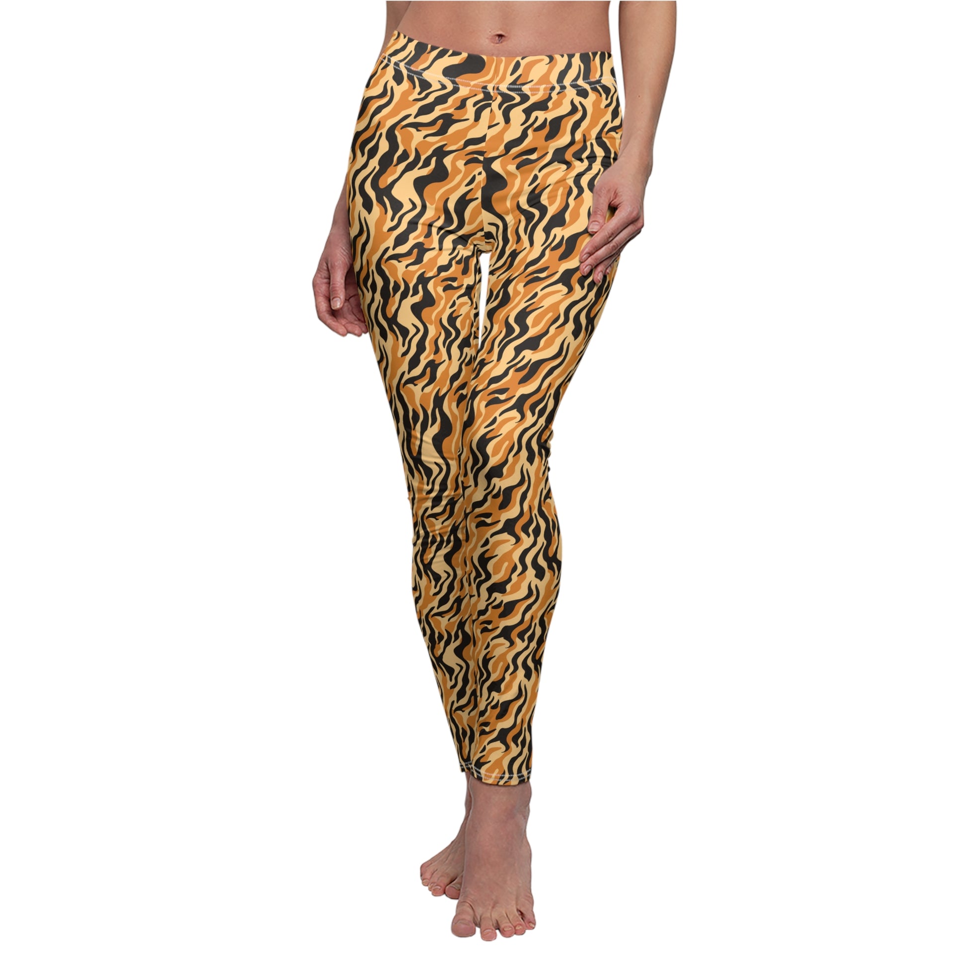 A person modeling a pair of full-length leggings with a bold wavy abstract pattern in mustard yellow, black, and orange against a plain white background. Trendy Animal Print Leggings for Active Lifestyles