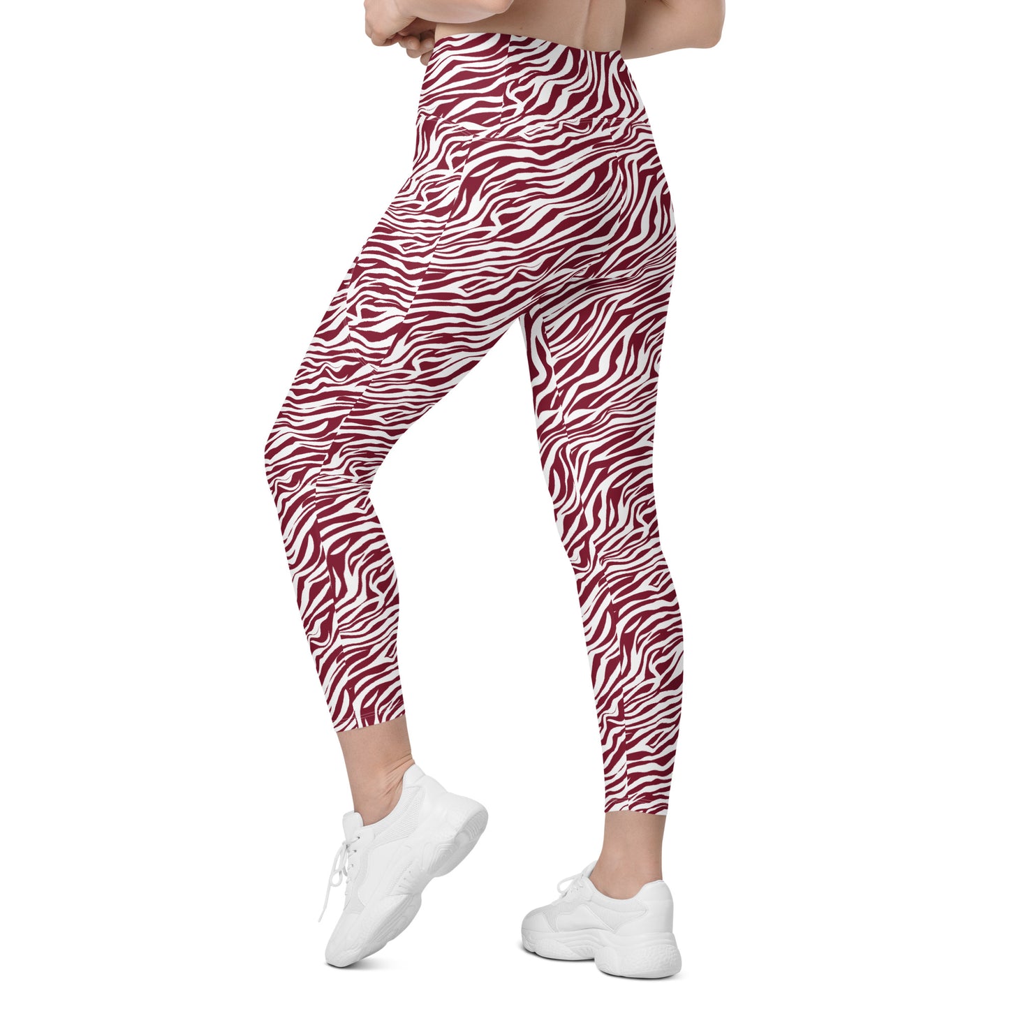 A person wearing high-waisted leggings with a red and white zebra print, paired with white sneakers, shown from the waist down against a plain white background. Trendy Comfortable Bold Red Zebra Print Leggings with Pockets for Activewear
