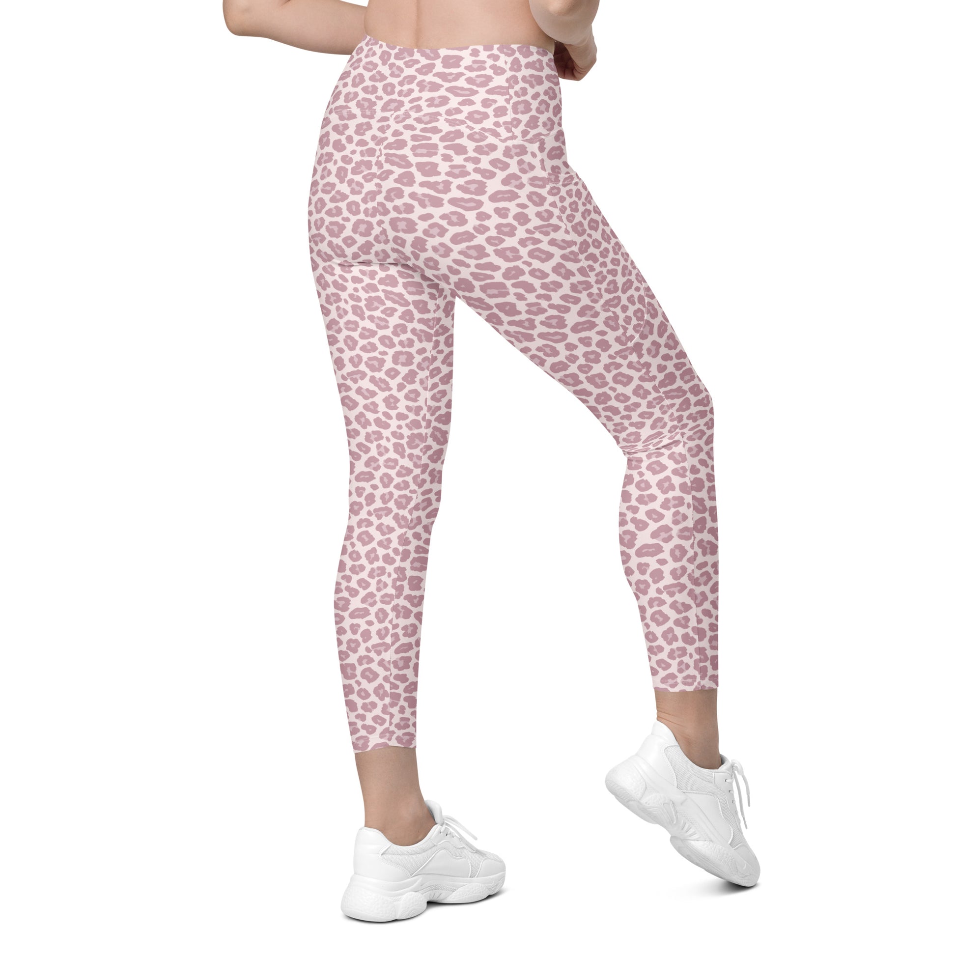 Pink leopard print leggings worn by a model, shown from the waist down with white sneakers against a plain white background. Trendy Pink Pastel Leopard Print Leggings with Pockets Activewear