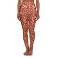 A person modeling high-waisted leggings with an all-over eye print on a solid white background. Tropical Leopard Print High-Waisted Yoga Leggings