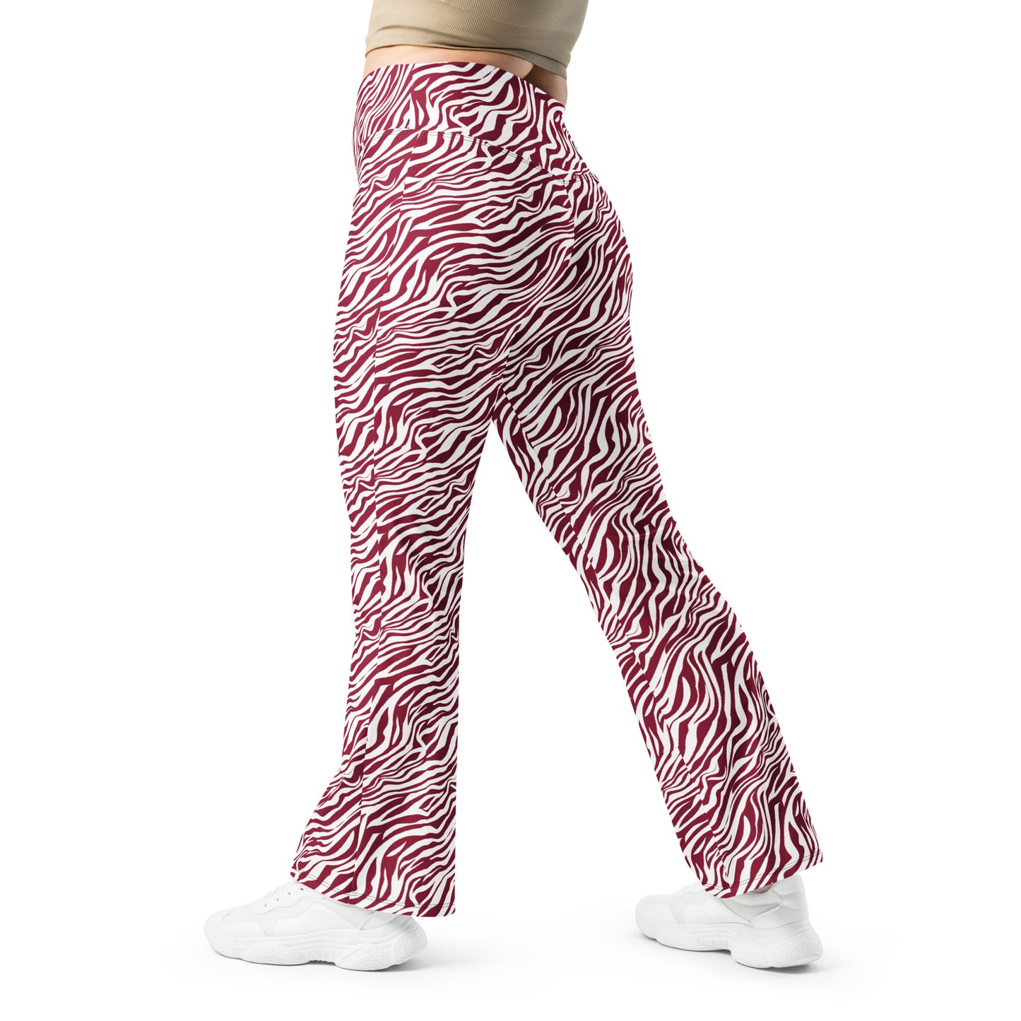 Red and white zebra-print flare pants modeled from the side, paired with white sneakers and a beige top against a plain white background. Unique Comfortable Bold Red Zebra Print Flare Leggings Activewear