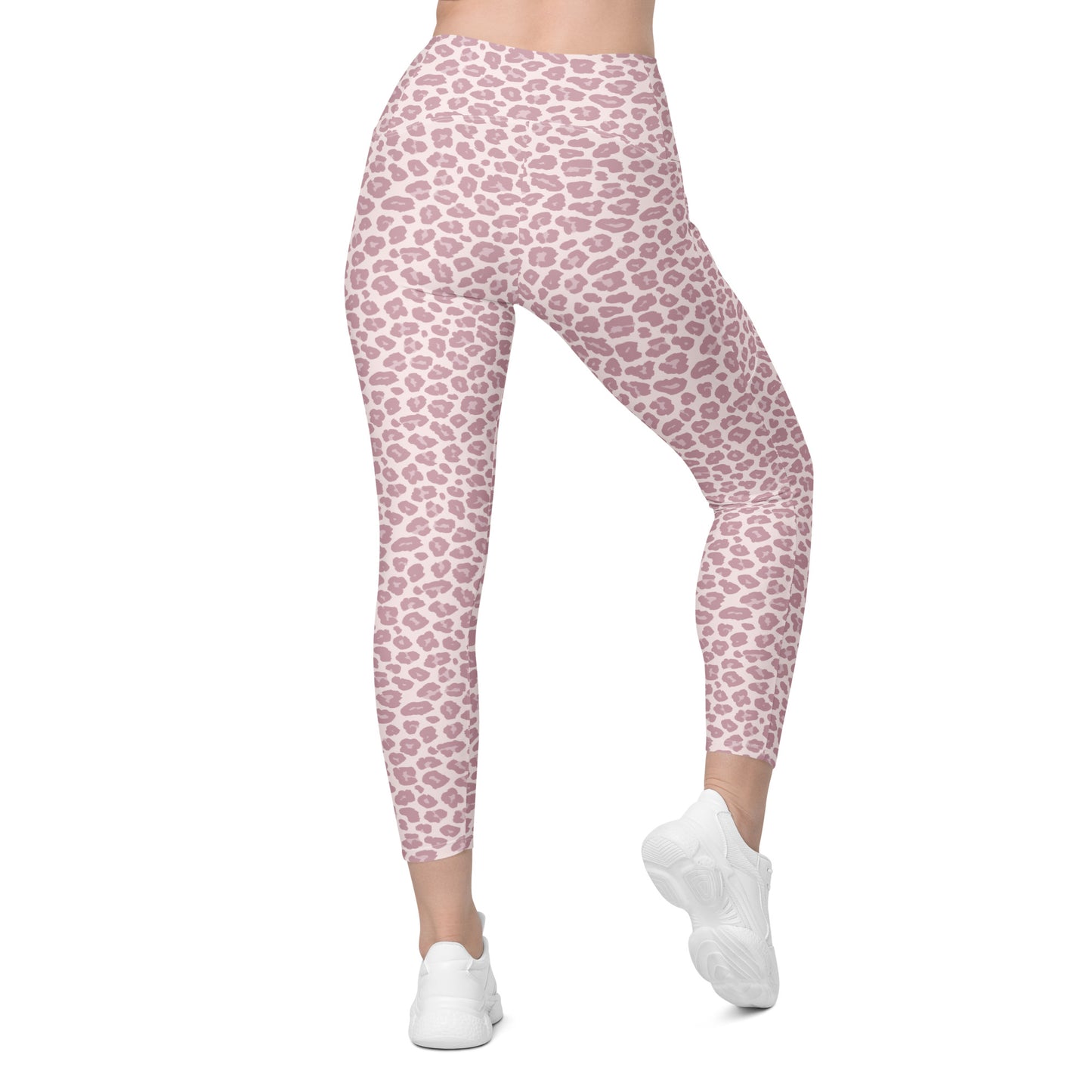 Pink leopard print leggings worn by a model, shown from the waist down wearing white sneakers against a plain white background. Unique Pink Pastel Leopard Print Leggings with Pockets Activewear