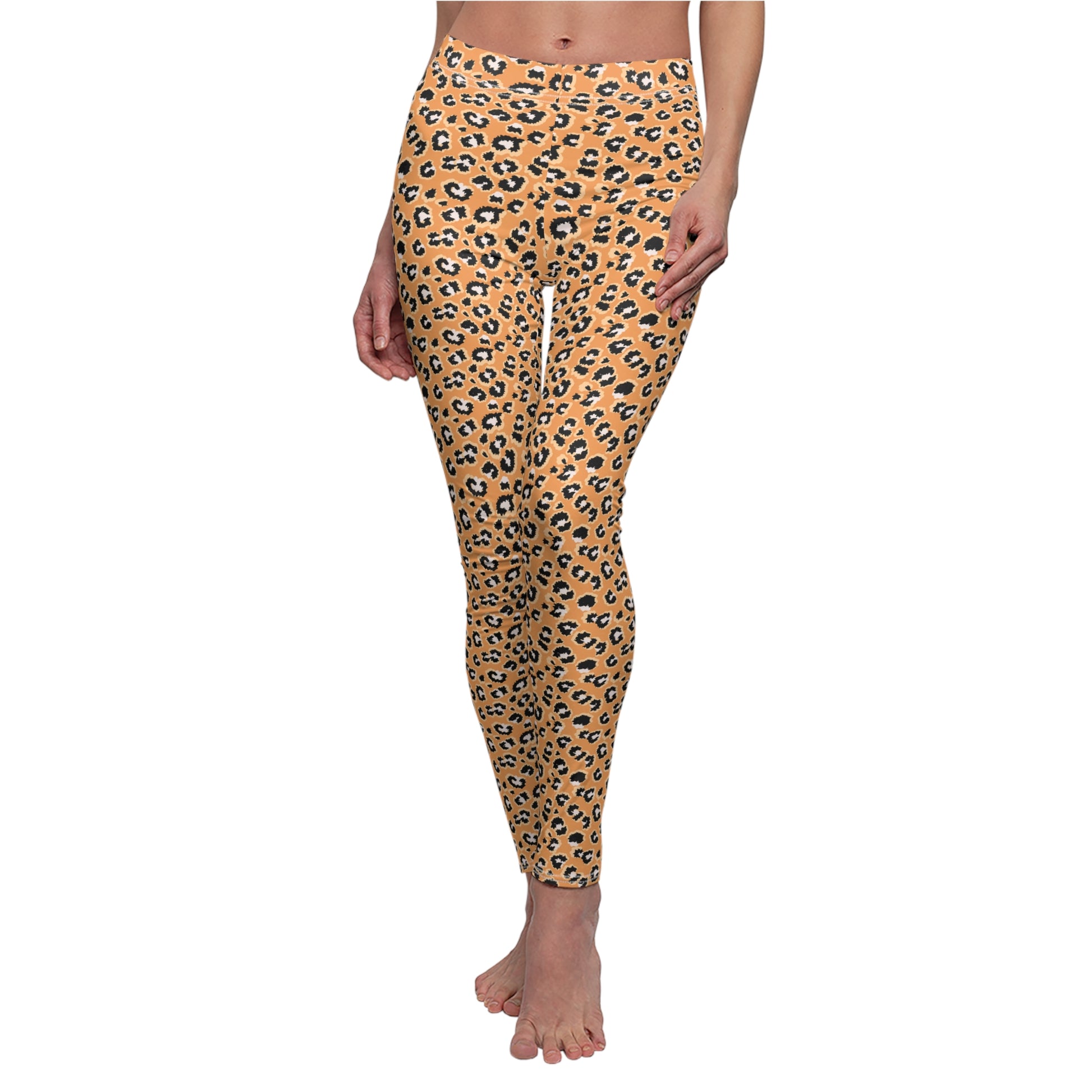 A person modeling leopard-print leggings against a plain white background. The leggings have a warm tan base with black and dark brown leopard spots. Vibrant Leopard Print Leggings for Bold Looks