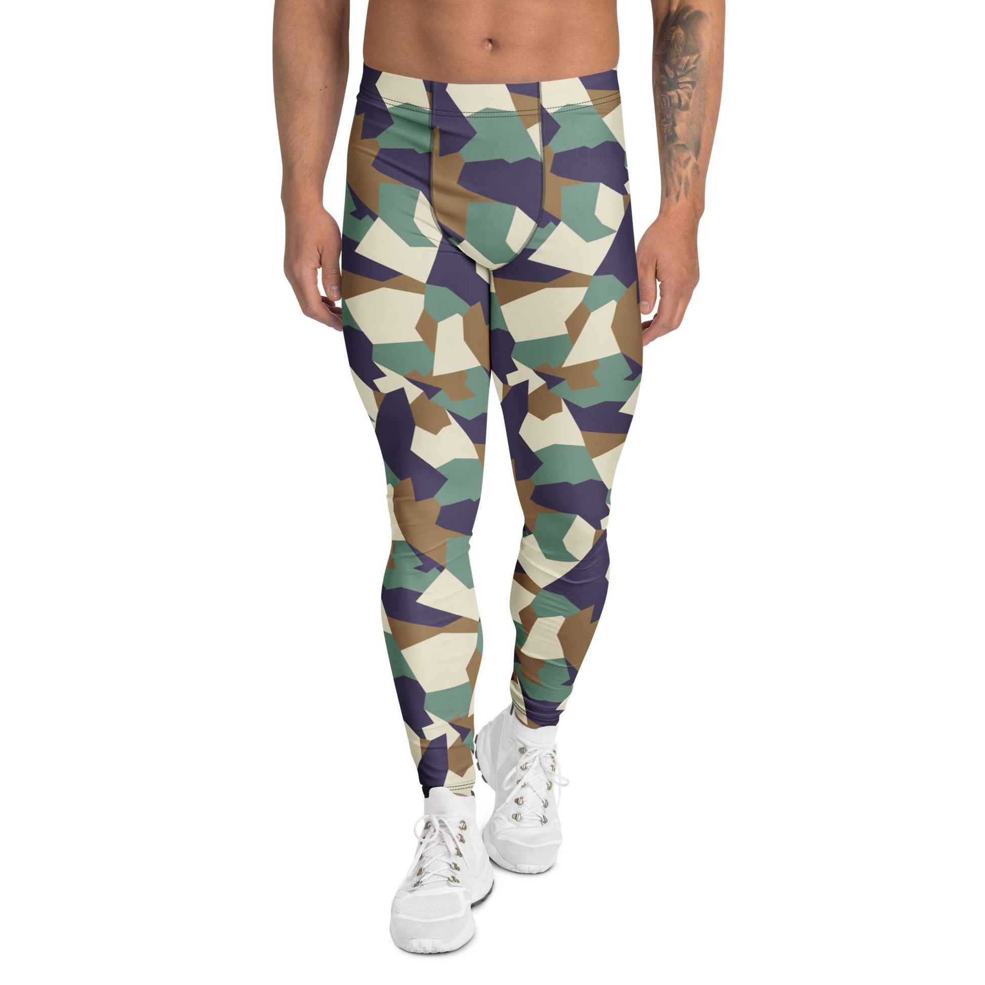 A person modeling high-waisted geometric camouflage leggings with white sneakers against a plain white studio background. Bold Colorful Camouflage Geometric Men's Leggings Activewear Shop Bold Colorful Camouflage Geometric Men's Leggings with a standout print, flexible fit, and all-day comfort for workouts or streetwear.