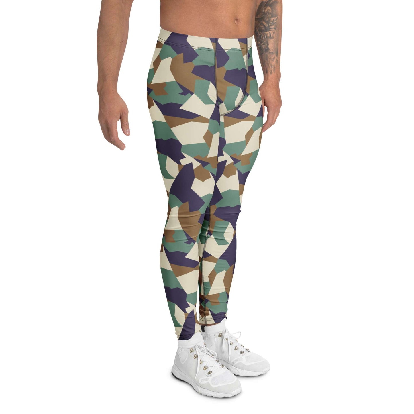 A model wearing high-waisted camouflage leggings with a geometric pattern in green, brown, navy, and beige, paired with white sneakers against a plain white background. Bold Colorful Camouflage Geometric Men's Leggings Activewear Shop Bold Colorful Camouflage Geometric Men's Leggings with a standout print, flexible fit, and all-day comfort for workouts or streetwear.