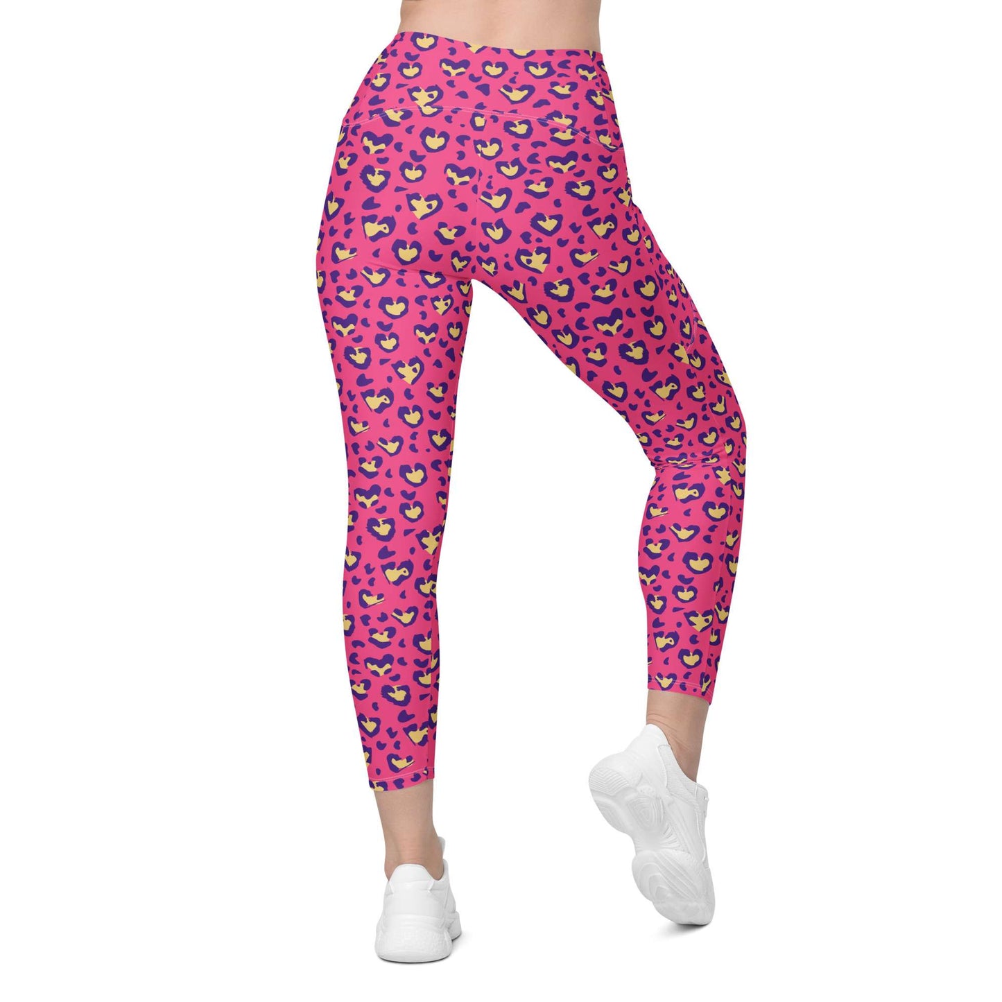 Pink high-waisted leggings with a colorful cartoon face pattern, shown on a model from the waist down wearing white sneakers against a plain white background. Heart Pink Leopard Pattern Leggings with Pockets Activewear Shop Heart Pink Leopard Pattern Leggings with Pockets Activewear, designed for bold workouts, everyday comfort, and convenient storage. Upgrade your workout wardrobe with Heart Pink Leopard Pattern Leggings with Pockets Activewear—stylish, practical, and made to move.