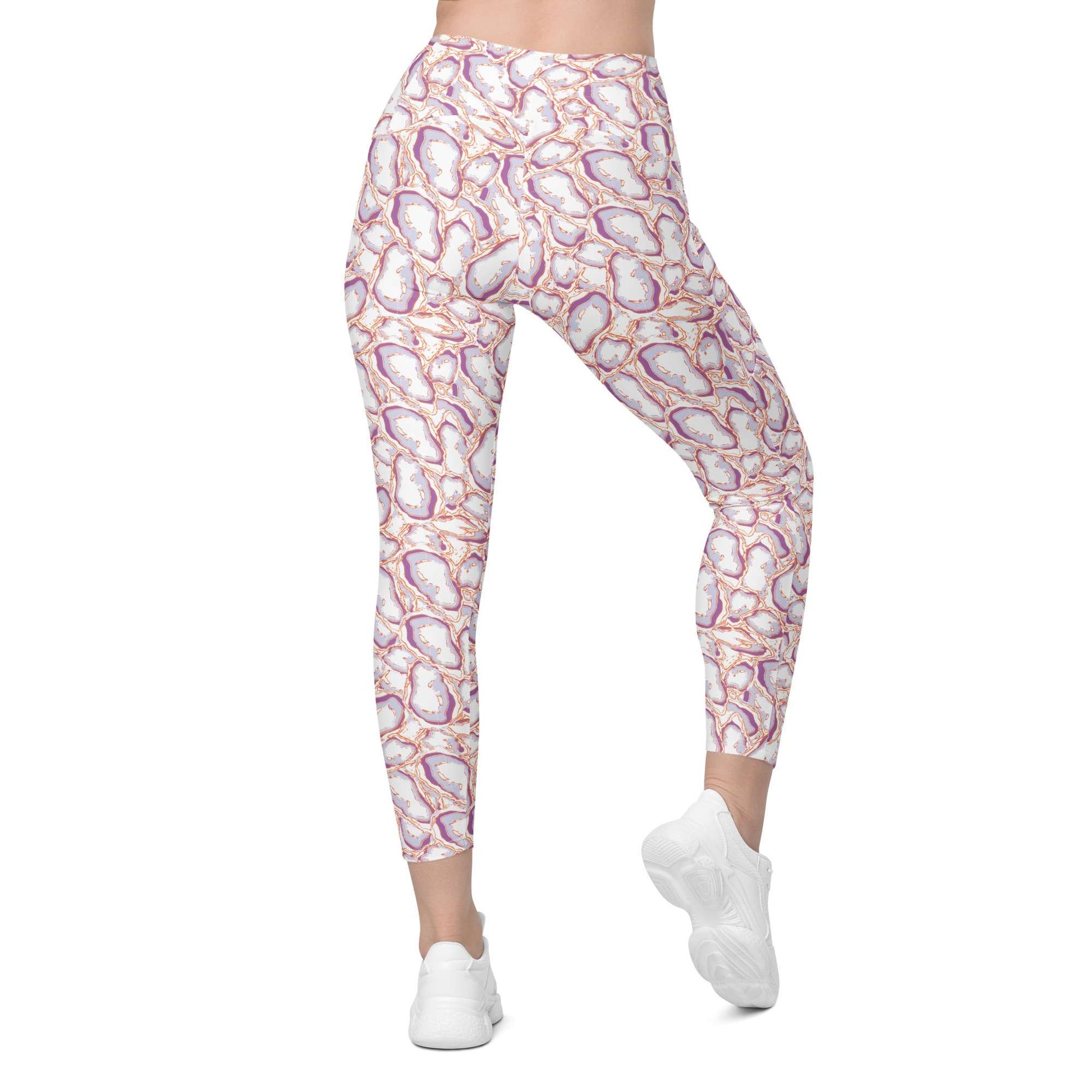 A person wearing high-waisted leggings with an abstract floral or geode-like print in white, pink, purple, and orange, paired with white sneakers, shown against a plain white background. Elegant Organic Marble Stone Leggings with Pockets Activewear Shop Elegant Organic Marble Stone Leggings with Pockets, designed for all-day comfort, flexible movement, and standout style. Elevate your activewear with Elegant Organic Marble Stone Leggings with Pockets, blending bold marble style, comfort, and function.