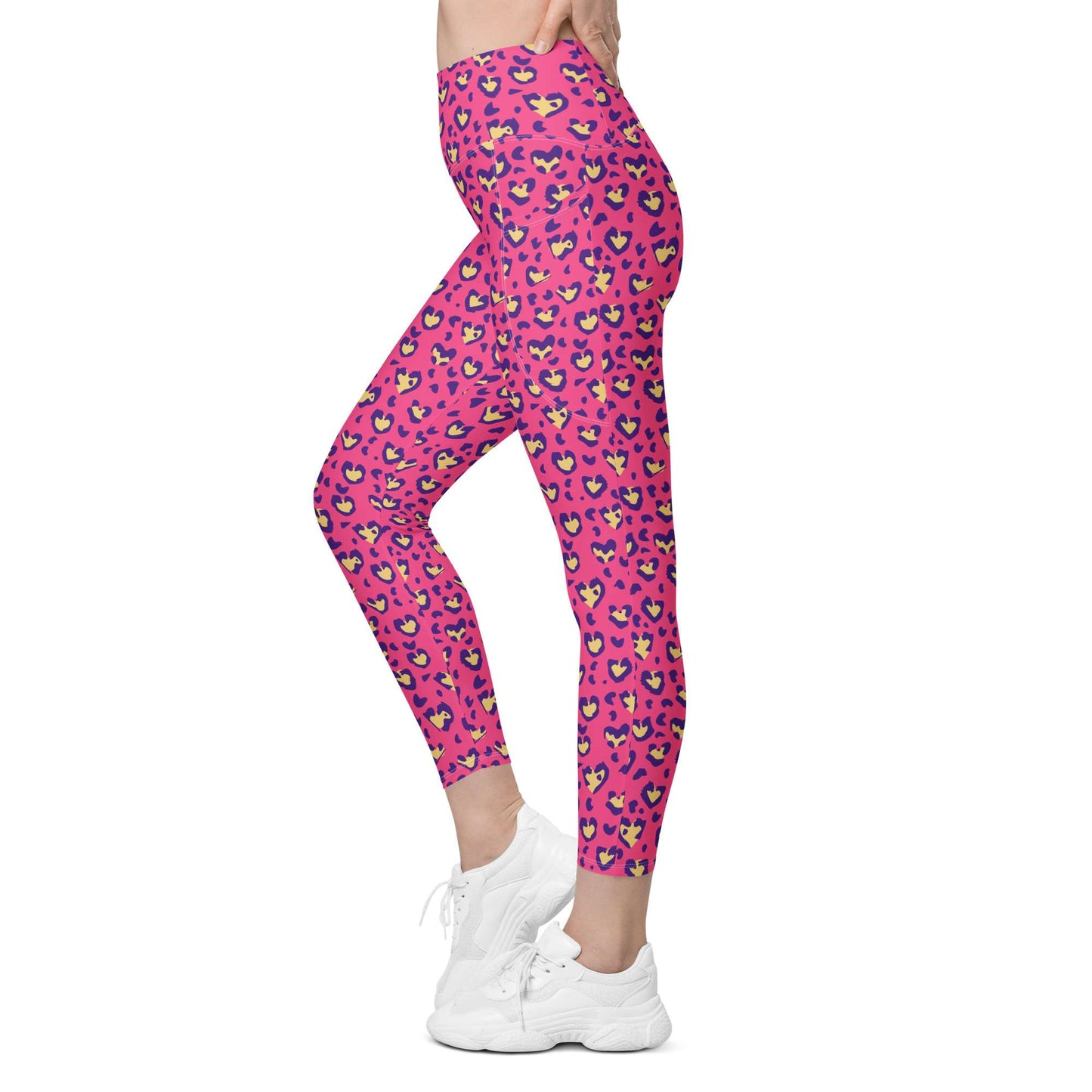 Pink leopard print leggings with purple, yellow, and blue spots, modeled on a person wearing white sneakers against a plain white background. Heart Pink Leopard Pattern Leggings with Pockets Activewear Shop Heart Pink Leopard Pattern Leggings with Pockets Activewear, designed for bold workouts, everyday comfort, and convenient storage. Upgrade your workout wardrobe with Heart Pink Leopard Pattern Leggings with Pockets Activewear—stylish, practical, and made to move.