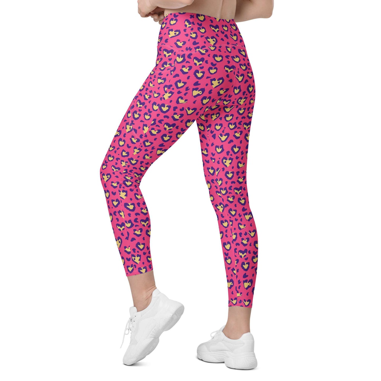 Pink high-waisted leggings with a colorful heart-and-leaf pattern, shown on a model from the waist down wearing white sneakers against a plain white background. Heart Pink Leopard Pattern Leggings with Pockets Activewear Shop Heart Pink Leopard Pattern Leggings with Pockets Activewear, designed for bold workouts, everyday comfort, and convenient storage. Upgrade your workout wardrobe with Heart Pink Leopard Pattern Leggings with Pockets Activewear—stylish, practical, and made to move.
