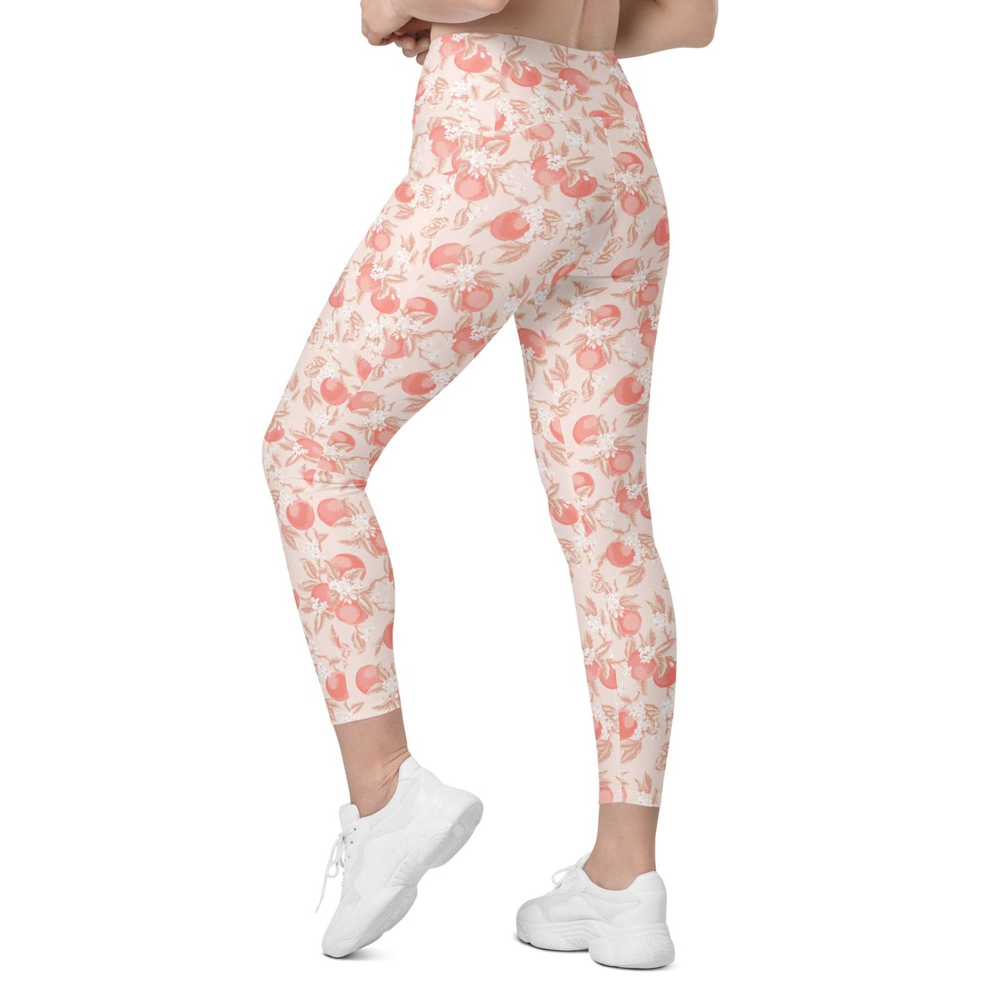 A person modeling high-waisted leggings with a peach and cream floral pattern, paired with white sneakers, shown from the waist down against a plain white background. Artistic Ditsy Floral Print Leggings with Pockets Activewear Artistic Stylized Ditsy Floral Pattern with Blue and Orange Botanical Motifs Leggings with Pockets Activewear Shop Artistic Ditsy Floral Print Leggings with Pockets, designed for bold outfits, flexible movement, and convenient everyday storage.