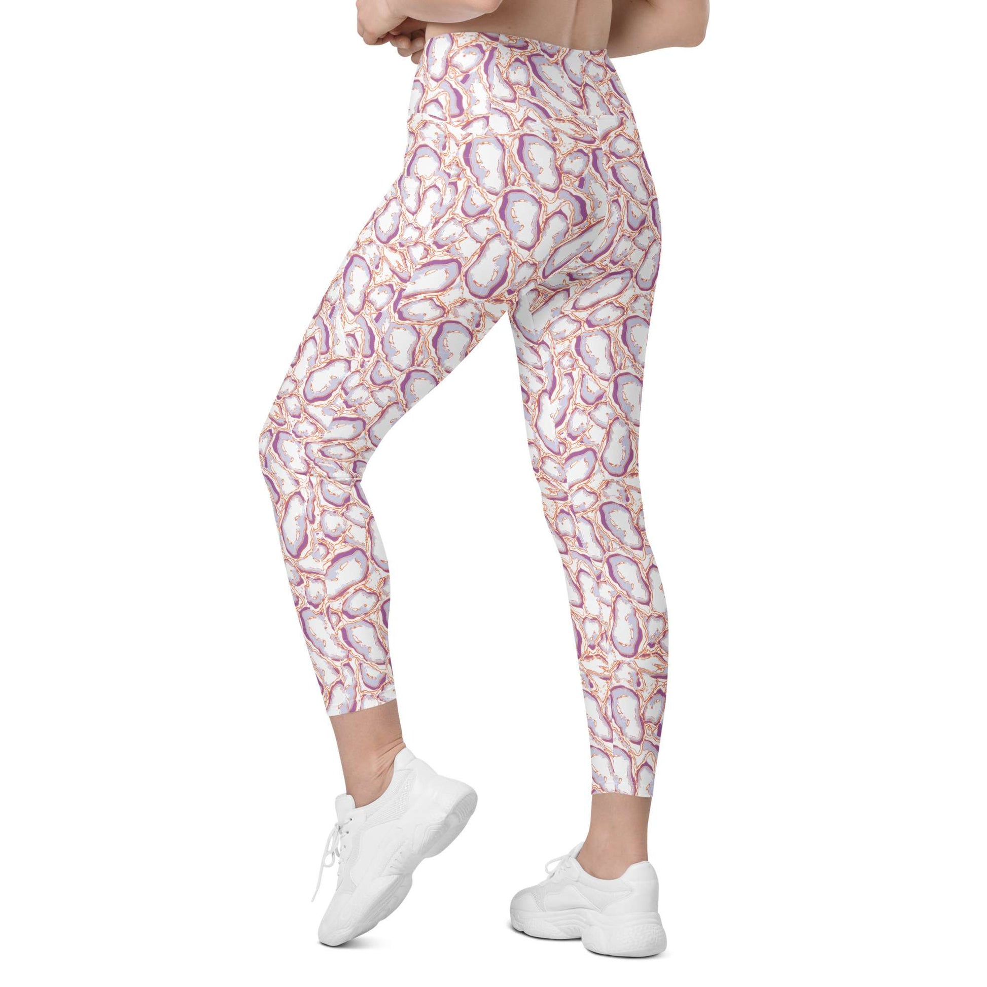 A person modeling high-waisted leggings with a white base and an abstract purple, pink, and orange geode or stone-like pattern, paired with white sneakers on a plain white background. Elegant Organic Marble Stone Leggings with Pockets Activewear Shop Elegant Organic Marble Stone Leggings with Pockets, designed for all-day comfort, flexible movement, and standout style. Elevate your activewear with Elegant Organic Marble Stone Leggings with Pockets, blending bold marble style, comfort, and function.