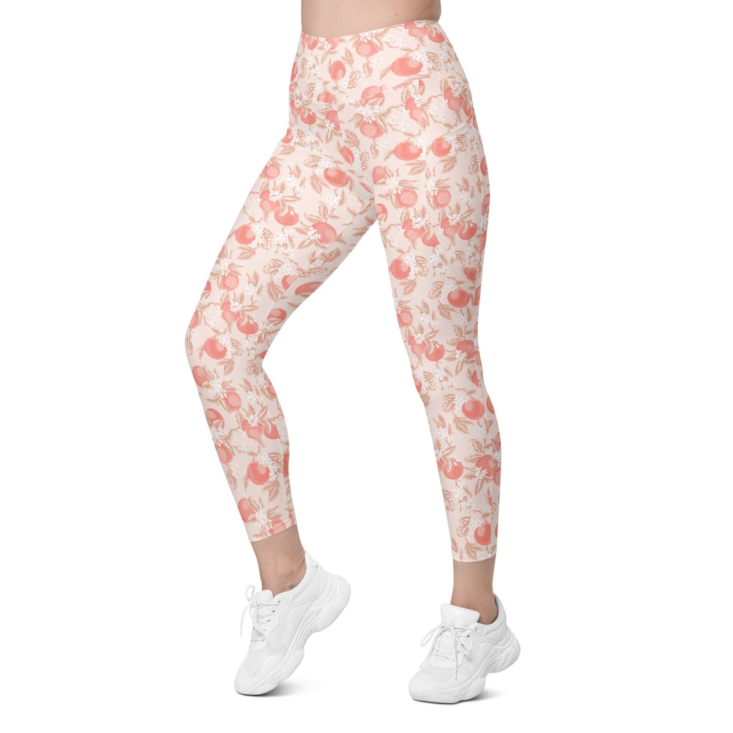 A model is wearing high-waisted leggings with a peach and pink watercolor floral pattern on a cream background, paired with white sneakers, shown against a plain white background. Artistic Ditsy Floral Print Leggings with Pockets Activewear Artistic Stylized Ditsy Floral Pattern with Blue and Orange Botanical Motifs Leggings with Pockets Activewear Shop Artistic Ditsy Floral Print Leggings with Pockets, designed for bold outfits, flexible movement, and convenient everyday storage.