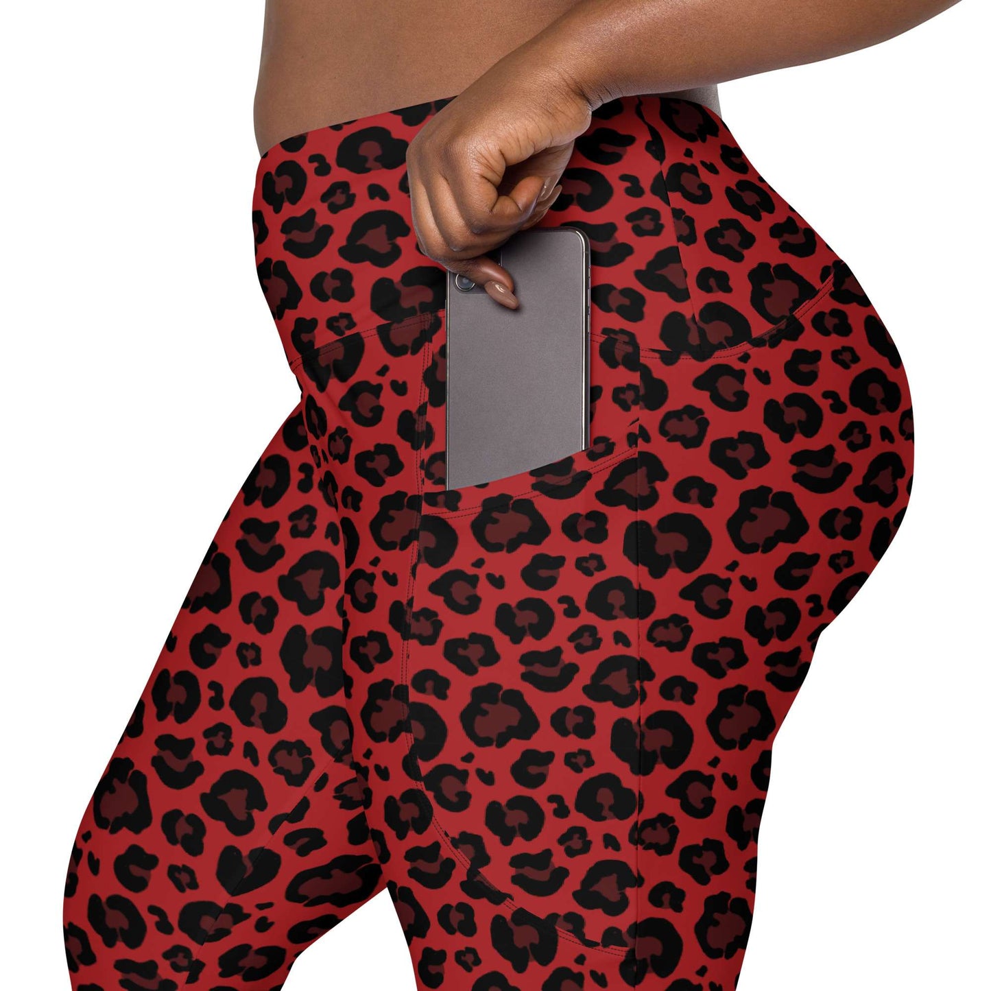 Red and black leopard print leggings with a side pocket shown on a model, with a gray smartphone inserted into the pocket. Bold Red Leopard Print Leggings with Pockets Activewear Shop Bold Red Leopard Print Leggings with Pockets Activewear for a fierce workout look, flexible comfort, and handy everyday storage.