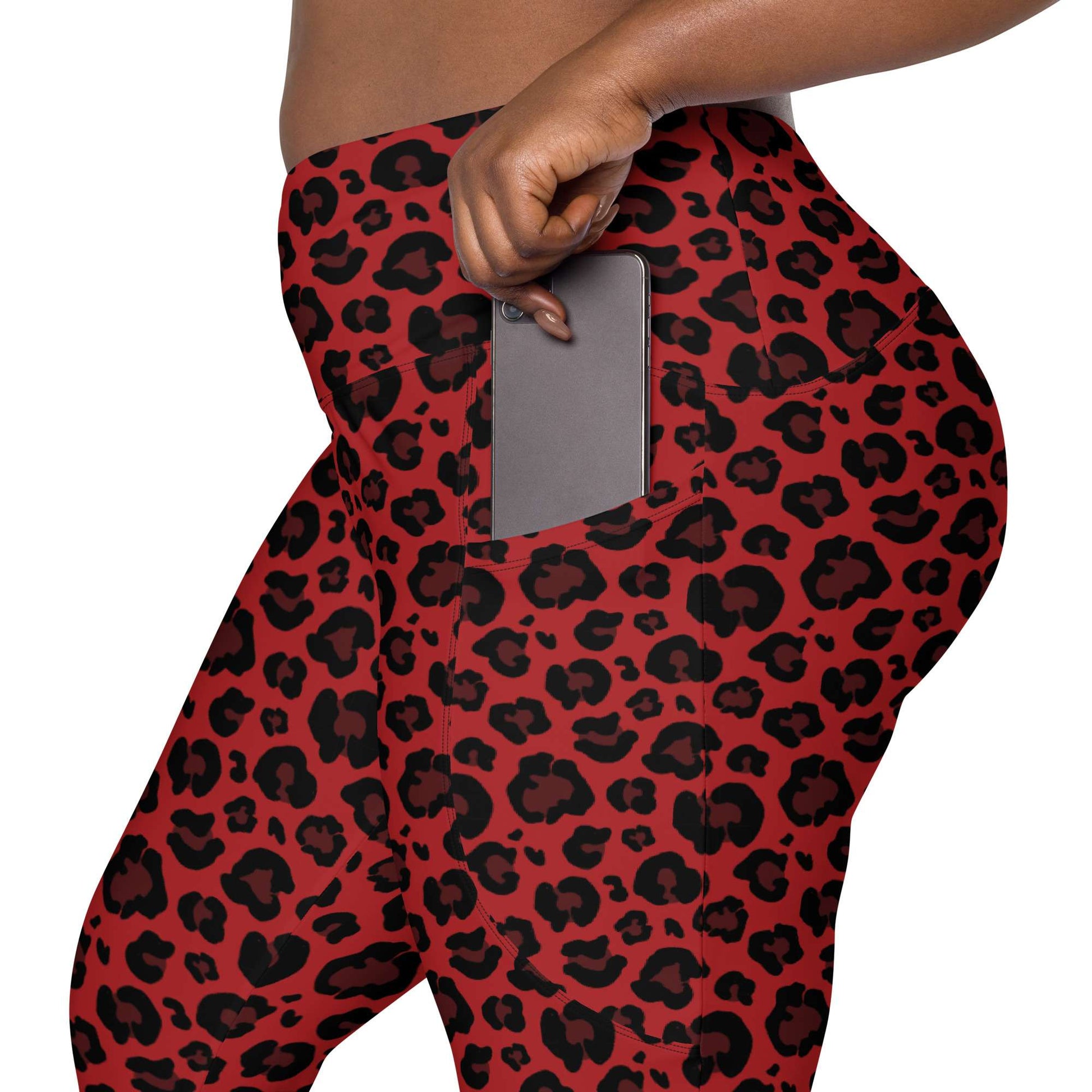 Red and black leopard print leggings with a side pocket shown on a model, with a gray smartphone inserted into the pocket. Bold Red Leopard Print Leggings with Pockets Activewear Shop Bold Red Leopard Print Leggings with Pockets Activewear for a fierce workout look, flexible comfort, and handy everyday storage.