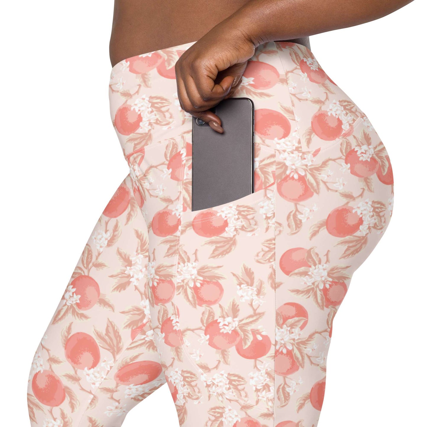 A close-up of a person wearing high-waisted light pink leggings with a side pocket holding a dark gray smartphone. Artistic Ditsy Floral Print Leggings with Pockets Activewear Artistic Stylized Ditsy Floral Pattern with Blue and Orange Botanical Motifs Leggings with Pockets Activewear Shop Artistic Ditsy Floral Print Leggings with Pockets, designed for bold outfits, flexible movement, and convenient everyday storage.