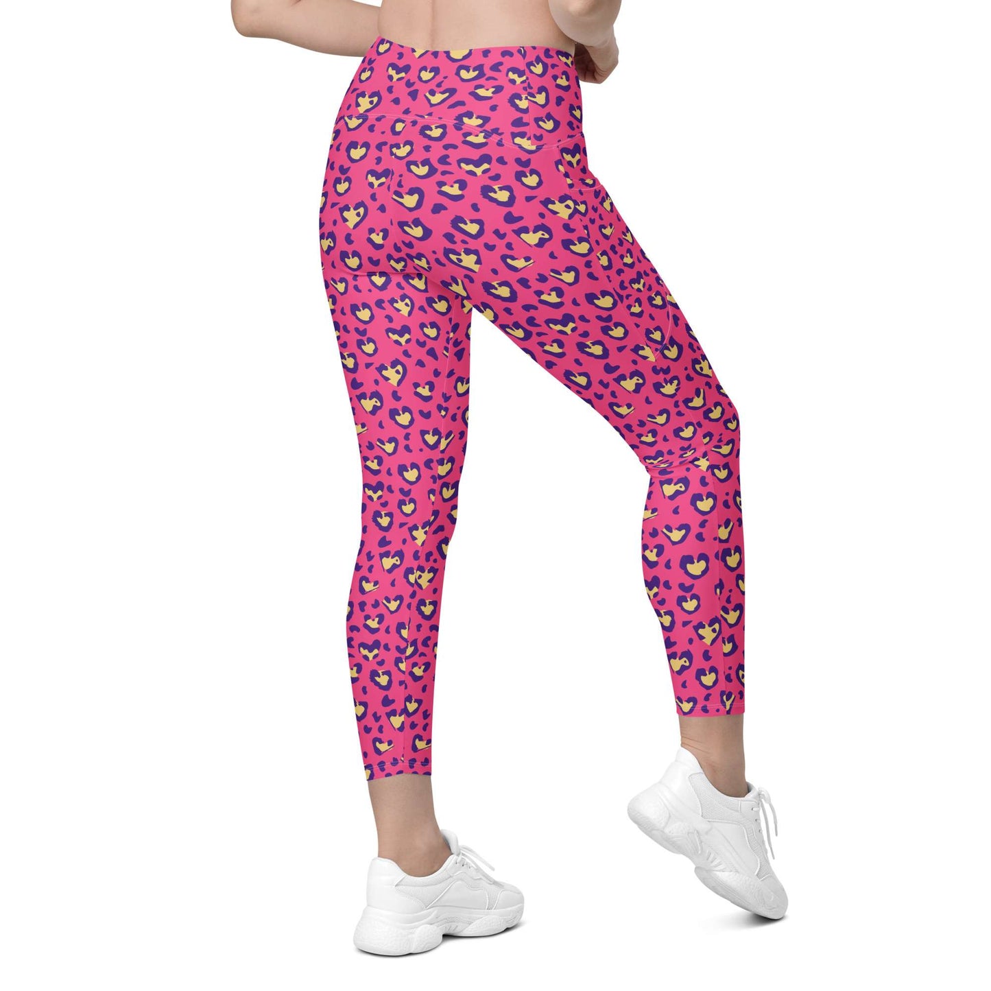 Pink leopard-print leggings with a colorful heart pattern, shown on a model from the waist down wearing white sneakers against a plain white background. Heart Pink Leopard Pattern Leggings with Pockets Activewear Shop Heart Pink Leopard Pattern Leggings with Pockets Activewear, designed for bold workouts, everyday comfort, and convenient storage. Upgrade your workout wardrobe with Heart Pink Leopard Pattern Leggings with Pockets Activewear—stylish, practical, and made to move.