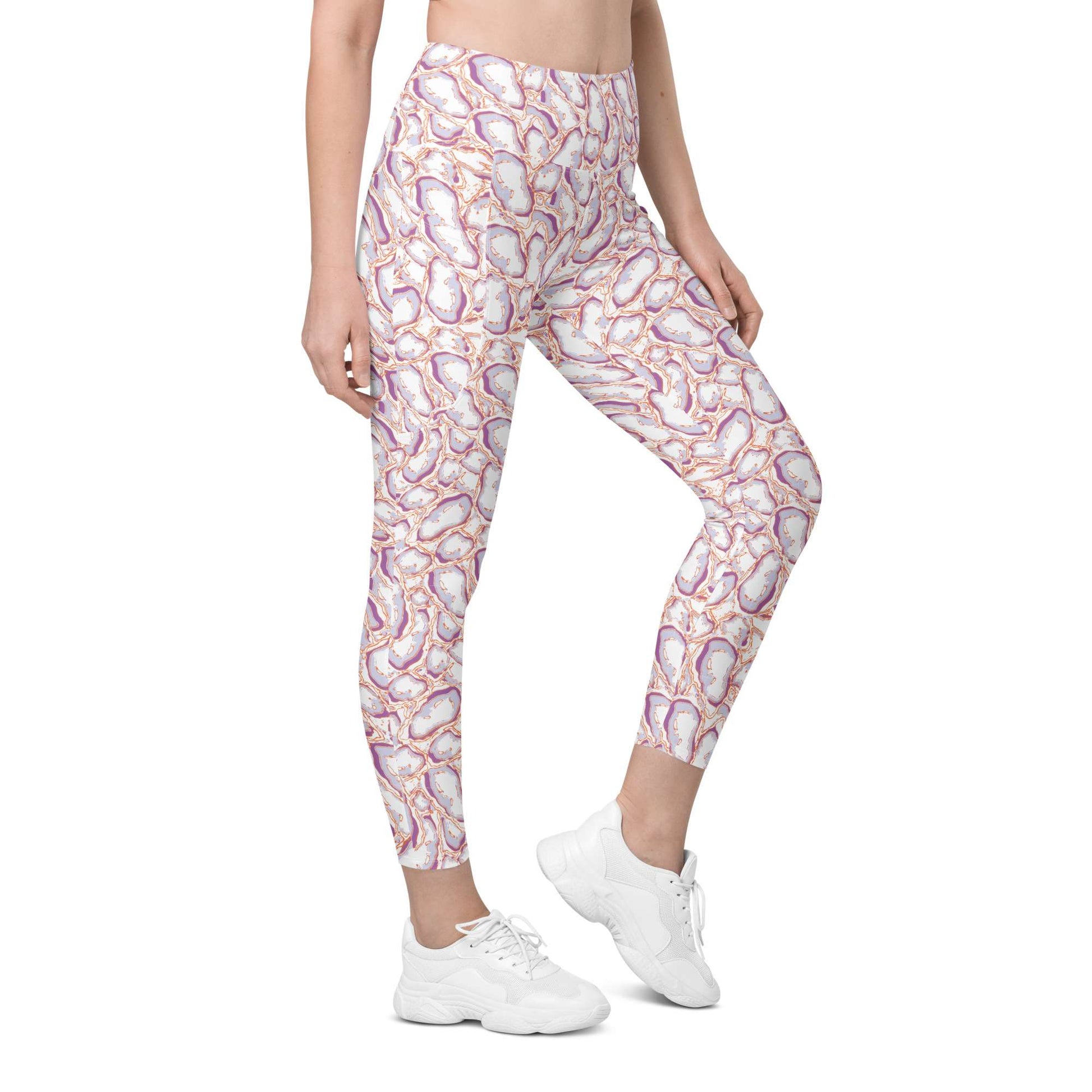 A model wearing high-waisted leggings with a colorful paisley pattern in pink, purple, orange, and white, paired with white sneakers, shown against a plain white background. Elegant Organic Marble Stone Leggings with Pockets Activewear Shop Elegant Organic Marble Stone Leggings with Pockets, designed for all-day comfort, flexible movement, and standout style. Elevate your activewear with Elegant Organic Marble Stone Leggings with Pockets, blending bold marble style, comfort, and function.